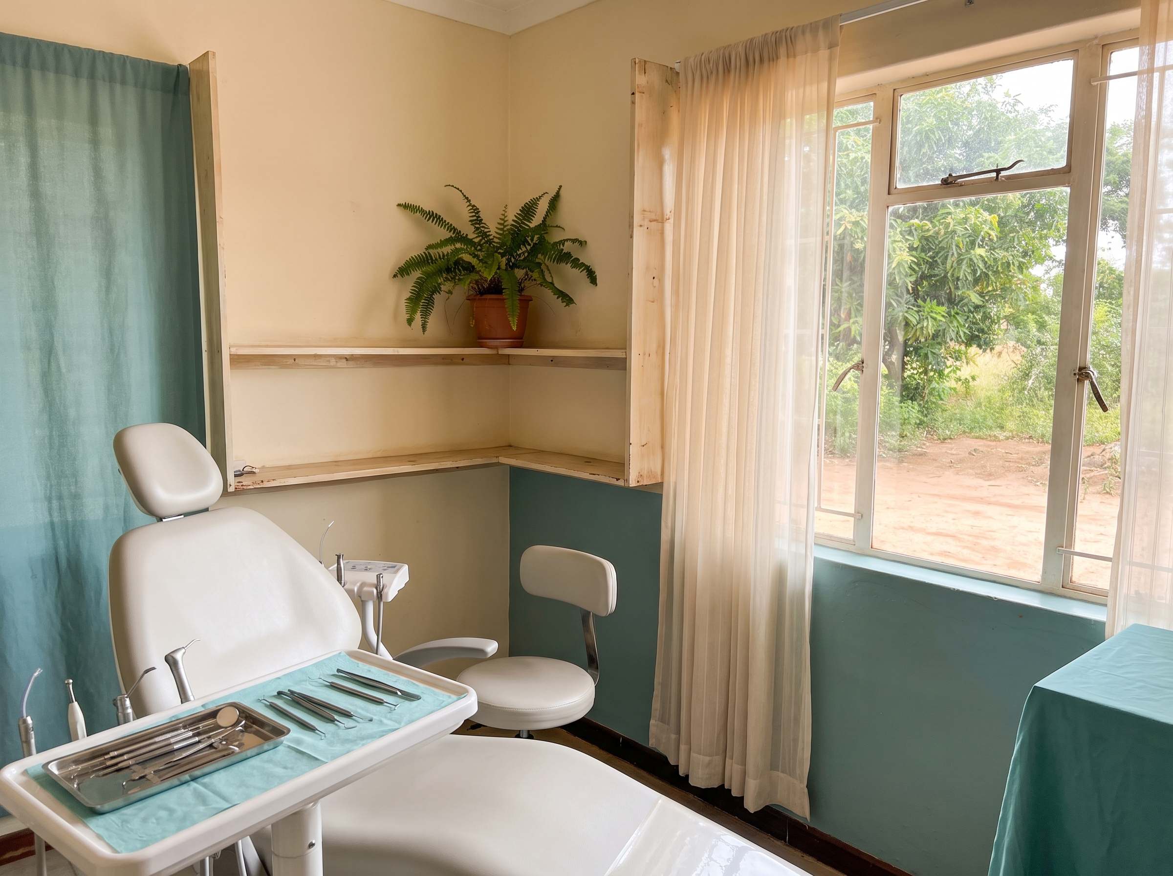 A treatment room at the practice, empty and lit by daylight from a large window.